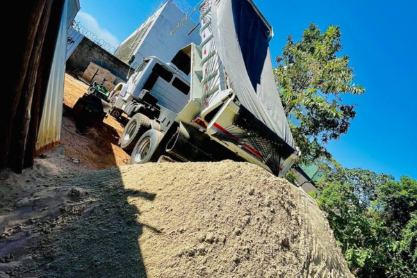 Caminhão entregando areia e pedra
